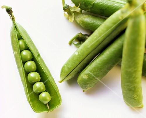 Several Sugar Snap Pea Pods, One Opened