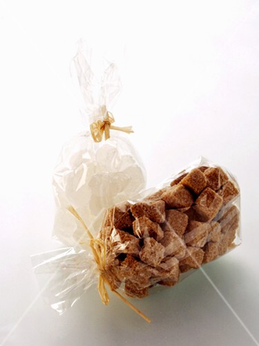 Brown and White Sugar Cubes in a Cellophane Bags