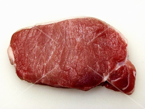 One Boneless Pork Chop on a Cutting Board