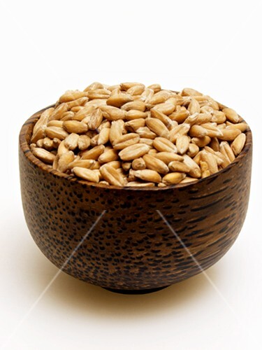 Spelt grains in brown bowl