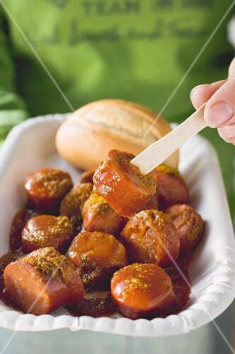 Eating currywurst with wooden fork