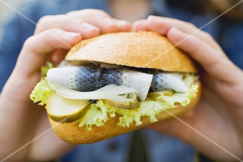 Hands holding a fish roll