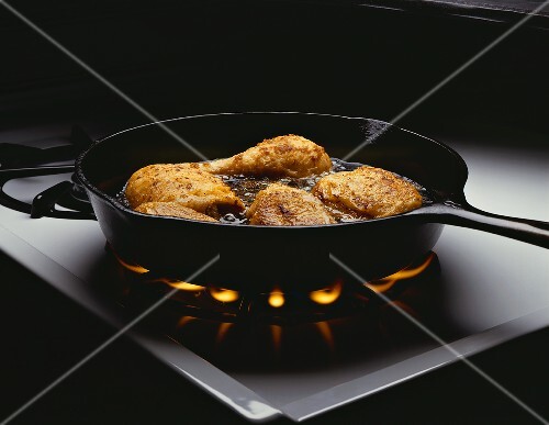Chicken Frying in Skillet on Stove
