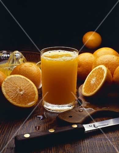 Glass of Fresh Squeezed Orange Juice with Fresh Oranges