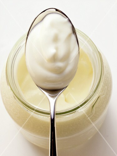 Yoghurt in jar and on spoon