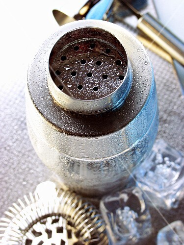 Cocktail shaker with drops of water (top view); bar utensils