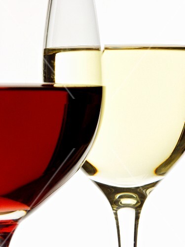 Red wine glass in front of white wine glass (close-up)