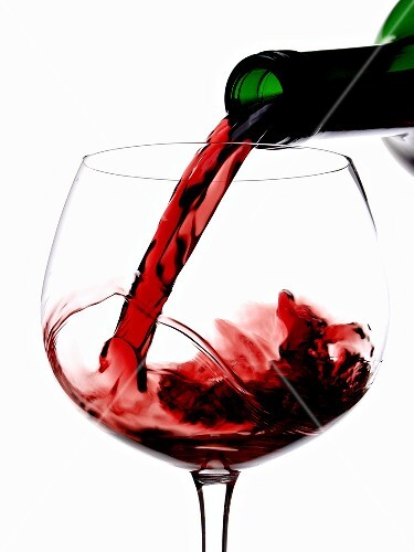 Pouring red wine into a glass