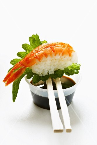 Nigiri sushi with shrimp and shiso leaf on soy sauce (1)