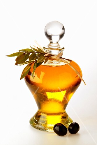 Olive oil with olive twig and olives