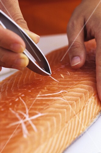 Removing the pin bones from a salmon fillet
