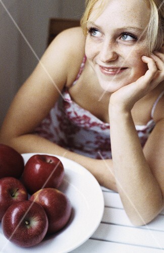 Young woman with red apples