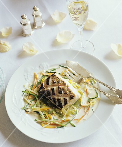 Red snapper with julienne vegetables and white sauce