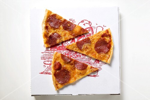 Three slices of pepperoni pizza on pizza box