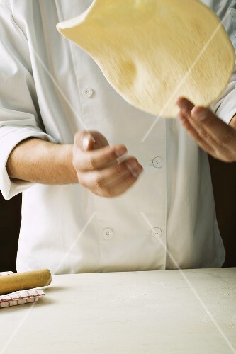 Shaping pizza dough (throwing it in the air)