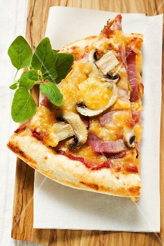 Slices of American-style ham and mushroom pizza