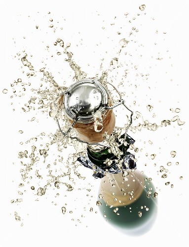 Cork flying out of a sparkling wine bottle