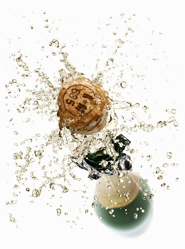 Cork flying out of a sparkling wine bottle