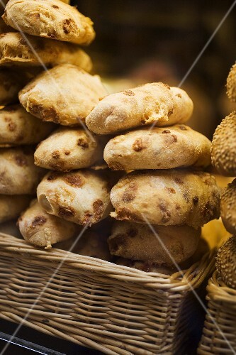 Various types of bread rolls in baskets at a market