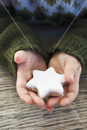 Child's hands holding cinnamon star