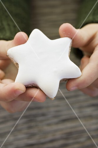 Child's hands holding cinnamon star