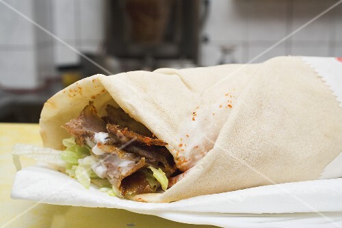 Döner wrap on paper napkin in snack bar
