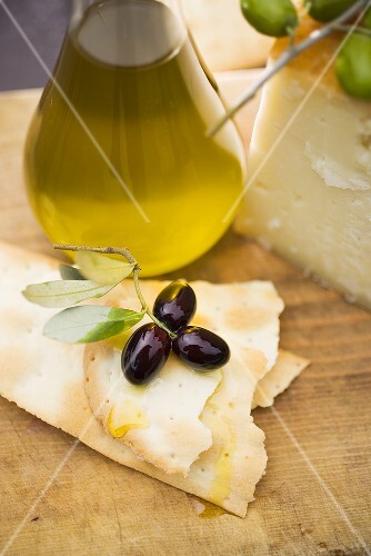 Olives, crackers, olive oil and Parmesan