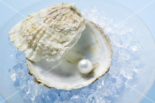 Pearl in oyster shell on crushed ice