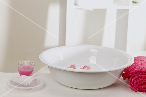Waschschüssel mit Blüten, Seife, Handtuch und Windlicht