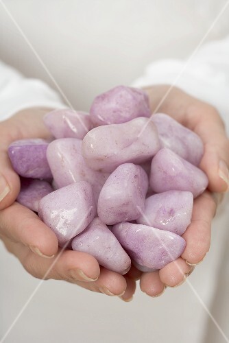 Hands holding healing stones