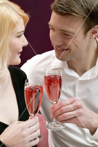 Couple clinking glasses of sparkling wine