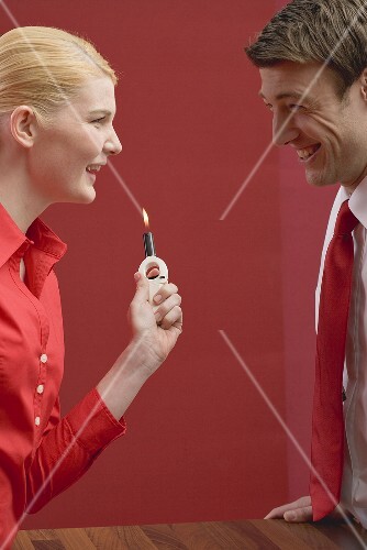 Laughing couple with gas lighter