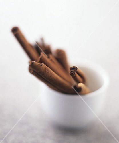 Several cinnamon sticks in a small pot