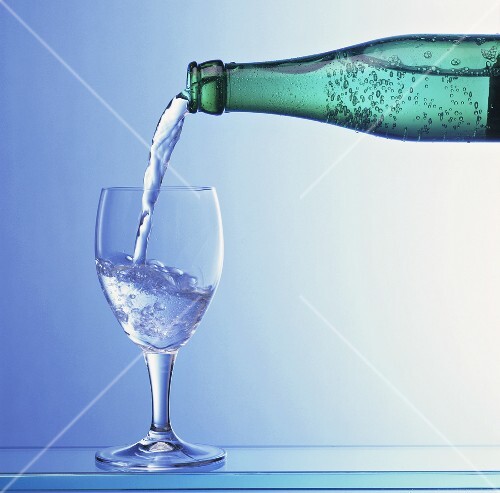 Water being poured from a bottle into a glass