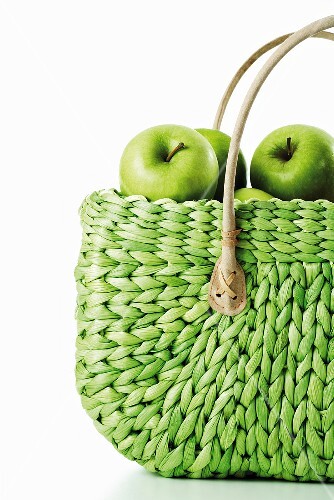 Granny Smith Äpfel in grünem Einkaufskorb