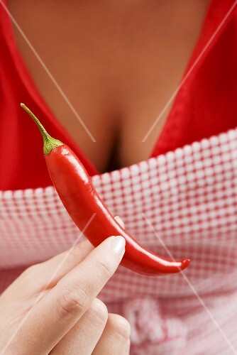 Woman holding red chilli