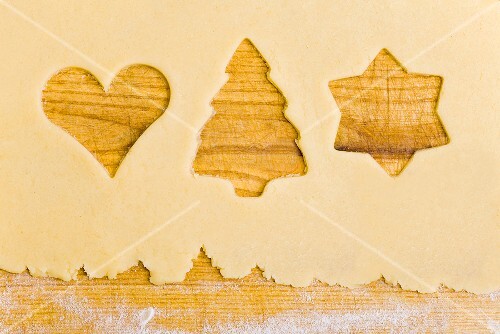 Biscuit dough with the shapes of cut-out biscuits