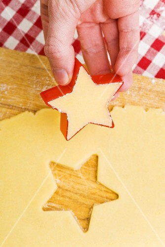 Cutting biscuits out of biscuit dough