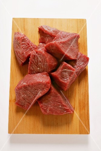 Diced beef on chopping board