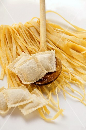 Home-made ribbon pasta and ravioli with kitchen spoon