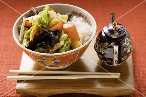 Vegetables and mushrooms cooked in wok on rice (China)