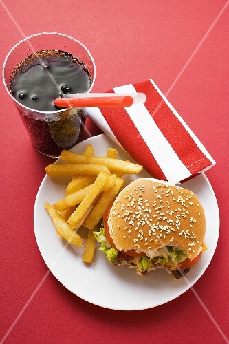 Cheeseburger, bites taken, with chips and Cola