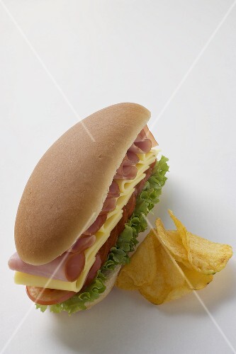Ham, cheese, tomato and lettuce sandwich with crisps