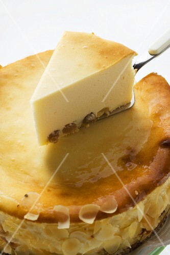 Cheesecake, a piece cut, with piece on server