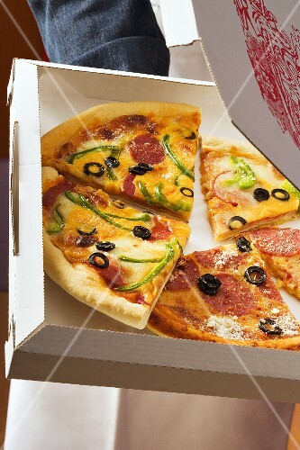 Pieces of different pizzas in pizza box