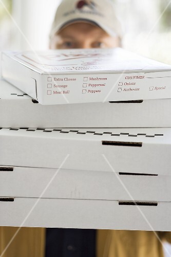 Several pizzas being delivered