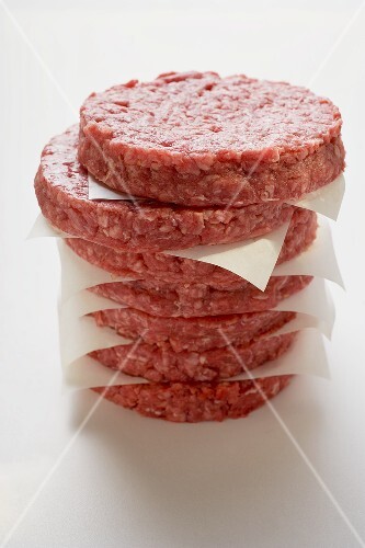 Raw burgers for hamburgers, in a pile