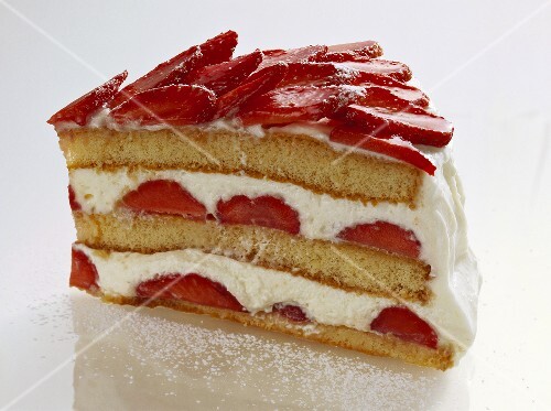 A piece of advocaat gateau with strawberries