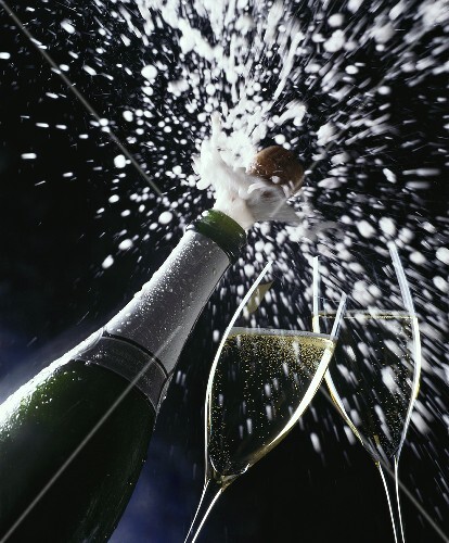 Cork flying out of sparkling wine bottle