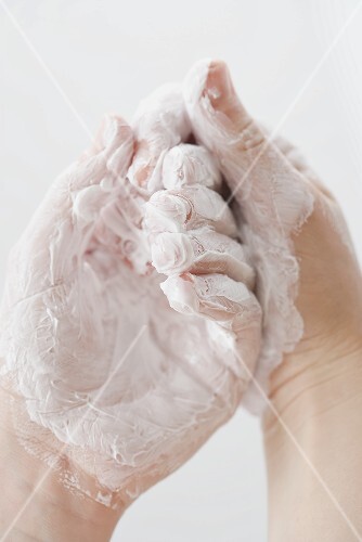 Hands covered in cream